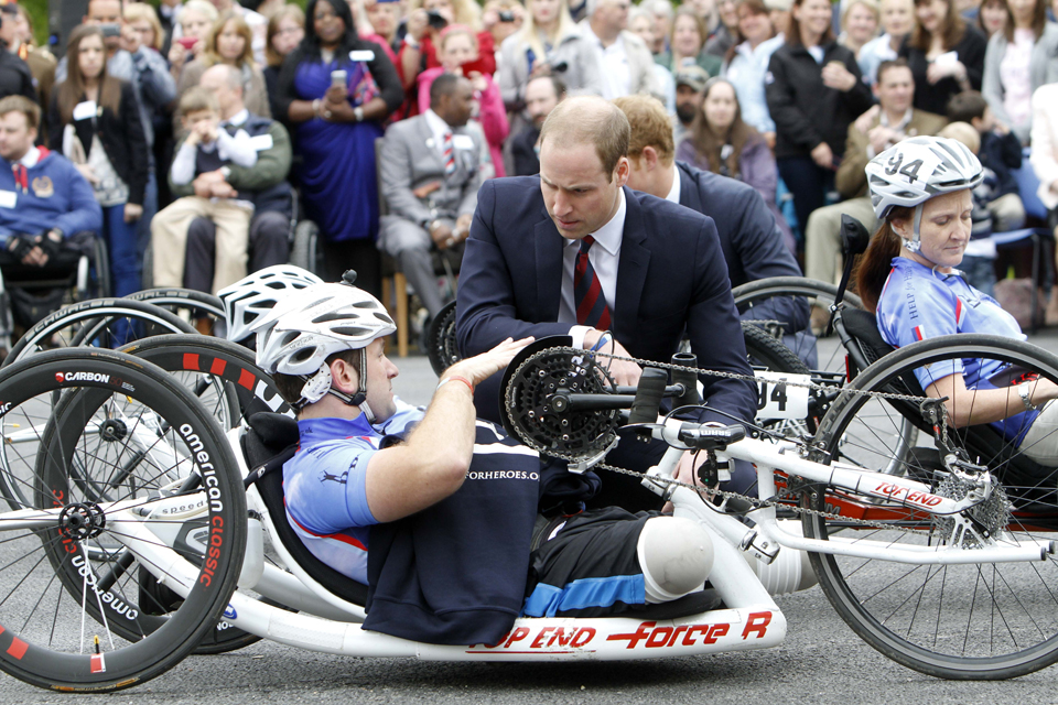 Prince William speaks with a wounded serviceman on a handcycle