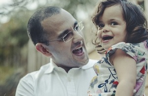 A parent holds up his child.