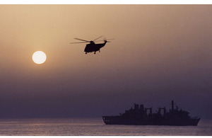 A Fleet Air Arm helicopter flies over RFA Fort Victoria