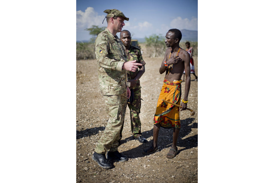 A member of the Military Stabilisation Support Group engaging with a Kenyan man