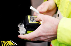 Policeman with breathalyser.