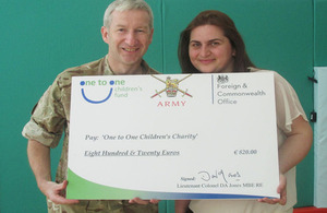 Lieutenant Colonel David Jones presenting a cheque to Liridona Zogaj, Project Director of One to One Children’s Fund