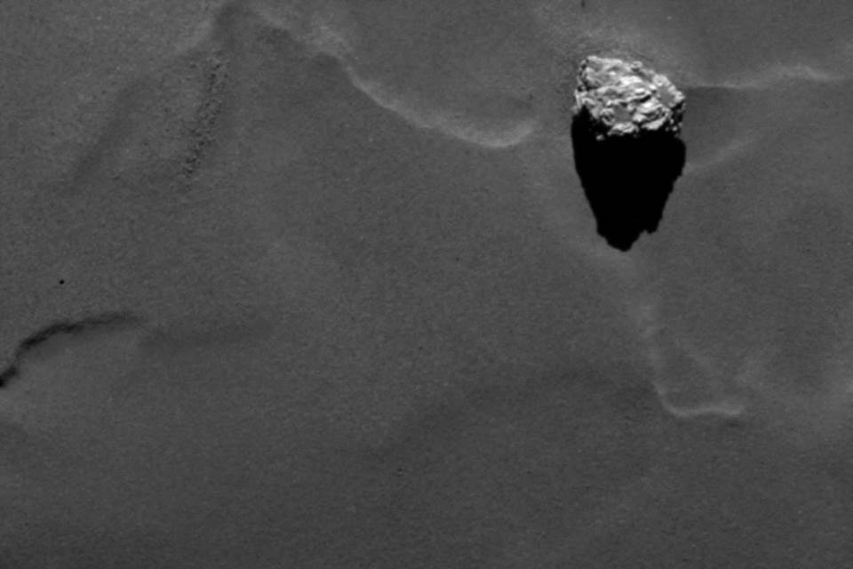 Close-up of the boulder Cheops as it casts a long shadow on the surface of comet 67P/Churyumov-Gerasimenko.