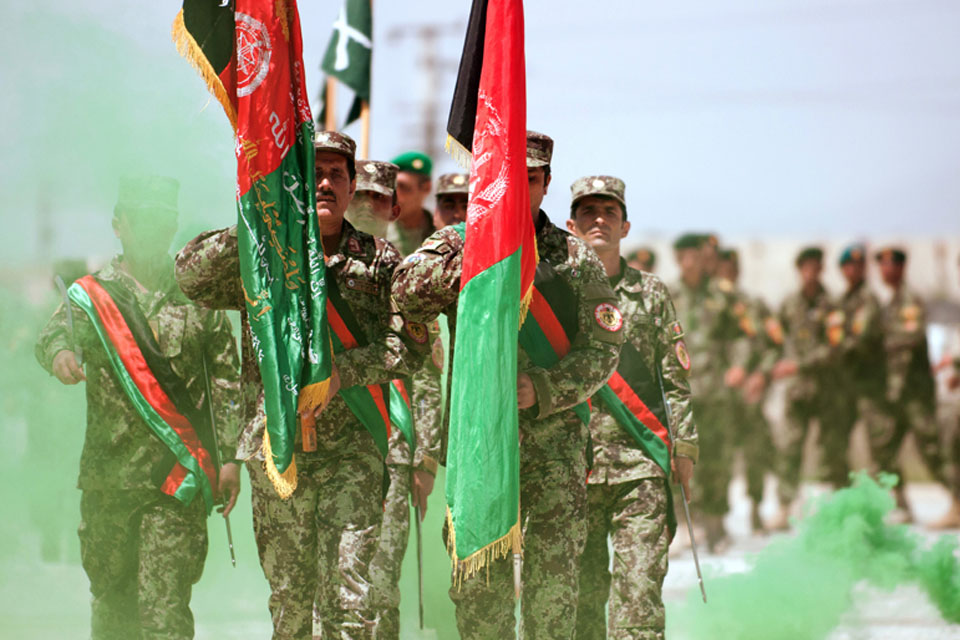 An Afghan National Army honour guard leads a parade formation of newly-graduated non-commisioned officers during a ceremony at Camp Ghazi, Kabul, Afghanistan 