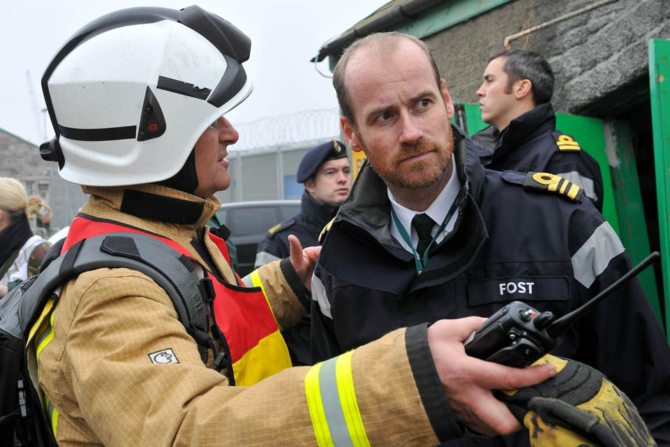 A member of the South Wales Fire and Rescue Service discusses options with a member of the Flag Officer Sea Training organisation