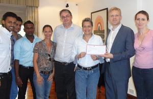 Presentation of a cheque by the British Deputy High Commissioner to the Director of Equal Ground