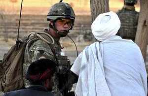 Corporal Jamie Williams speaks with an Afghan man in Alokozi Shah, south of Popalzai Kalay, near Helmand's capital, Lashkar Gah