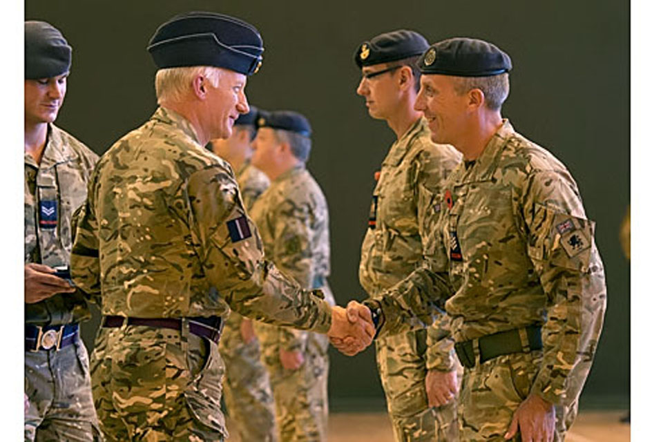 Air Chief Marshal Sir Stephen Dalton shakes hands with a member of the RAF Police