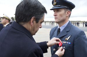 Royal Air Force Flight Lieutenant Ian Abson receives the Croix de la Valeur Militaire with bronze star from the Prime Minister of France, François Fillon