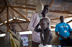 A child is weighed as part of a nutritional assessment in Unity State, South Sudan, December 2016. Picture: UNICEF/Kate Holt