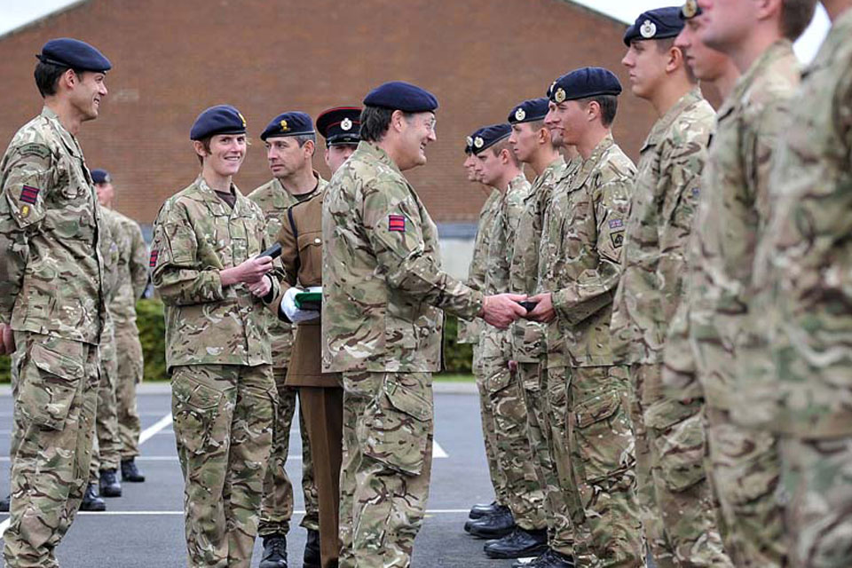 Lieutenant General Sir Mark Mans presents campaign medals to members of 26 Engineer Regiment 