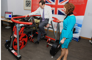 Minister for Defence Equipment, Support and Technology Peter Luff tries out an exercise bike, modified for use by injured Service personnel, at the Centre for Defence Enterprise exhibition