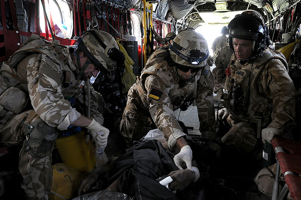 Members of a Medical Emergency Response Team treat a casualty in the back of a Chinook helicopter during transit to Camp Bastion field hospital (stock image)