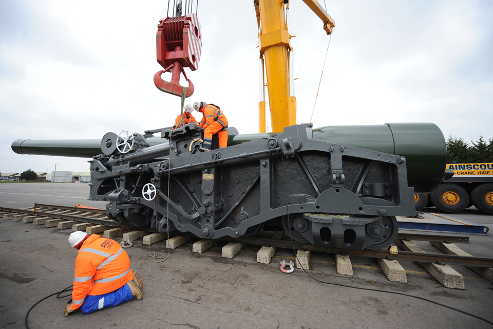 Specialists work to dismantle the gun for transport to the Netherlands