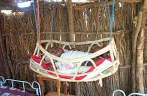 Baby in cradle moved away from smoke in Sudan