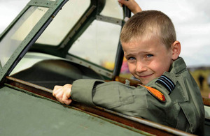 Seven-year-old Charlie Parrott sits in the cockpit of a replica Hurricane at RIAT 2010