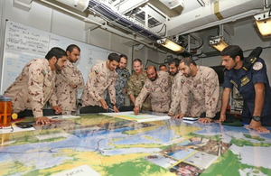 Emirati staff conducting a planning exercise in HMS Ocean prior to the Ex SEA KHANJAR 17 final assault