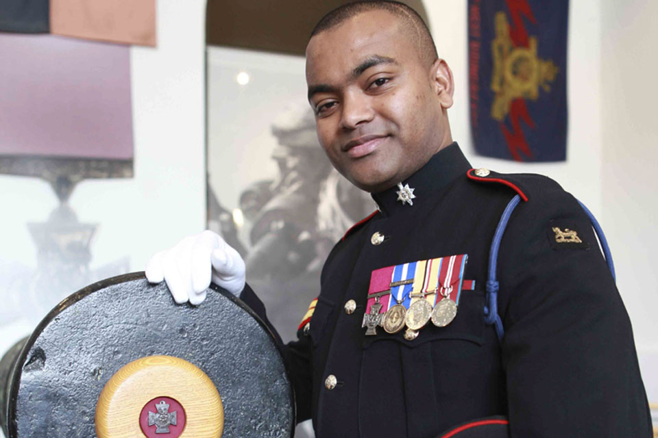 Corporal Johnson Beharry with one of the guns from which the Victoria Cross is struck