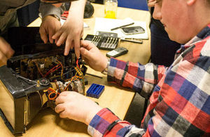 People taking apart an appliance