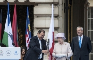 HM Queen Elizabeth II putting a message in the baton on 09 October 2013 in London