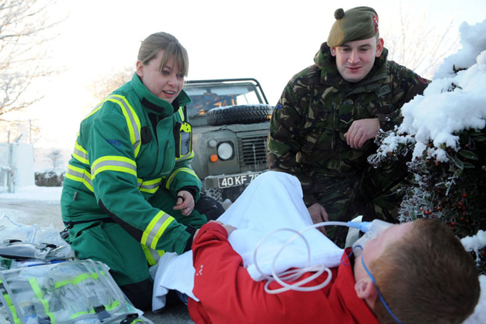 Jacqui Methven, a SORT (Special Operations Response Team) paramedic with the Scottish Ambulance Service, and territorial soldier Lance Corporal Mark McVey help a fallen casualty as local temperatures plummet to minus 14 degrees