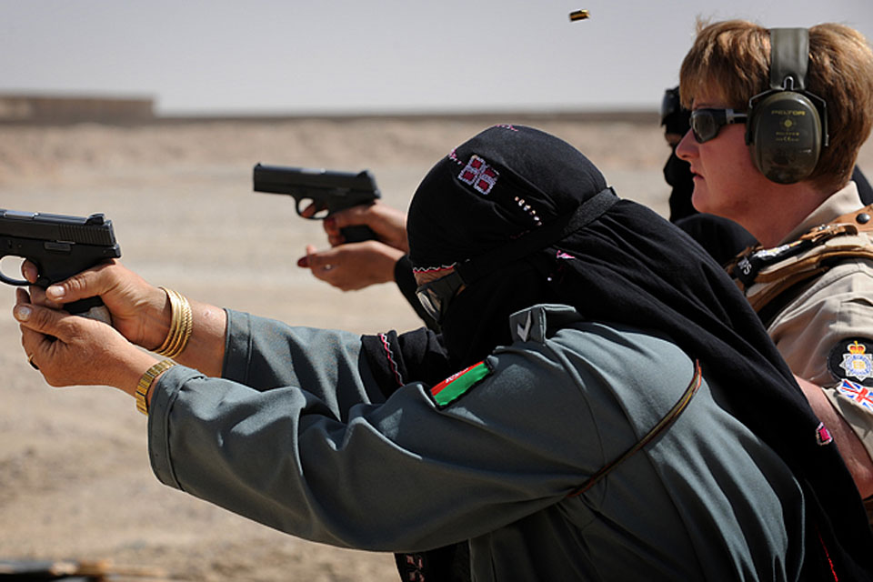 MOD police officer Isabella McManus observes female Afghan police officers on the firing range