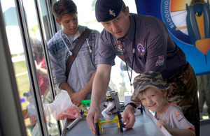 Staff Sergeant Matt Chapman and a child launch a toy vehicle they built at the Goodwood Festival of Speed [Picture: Crown copyright]