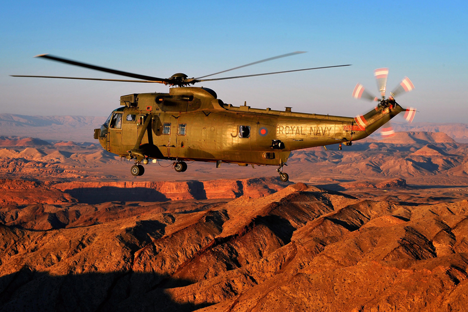 A Sea King helicopter flies over the Jordanian desert