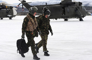 Admiral George Zambellas (left) walks out onto the flight line at Bardufoss airfield