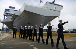 Sailors march past HMS Queen Elizabeth at the naming ceremony [Picture: Chief Petty Officer Airman (Photographer) Tam McDonald, Crown copyright]