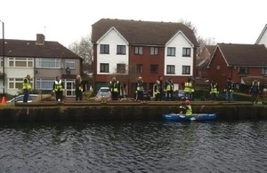 A photo showing volunteers helping to put a new fish habitat in a river.
