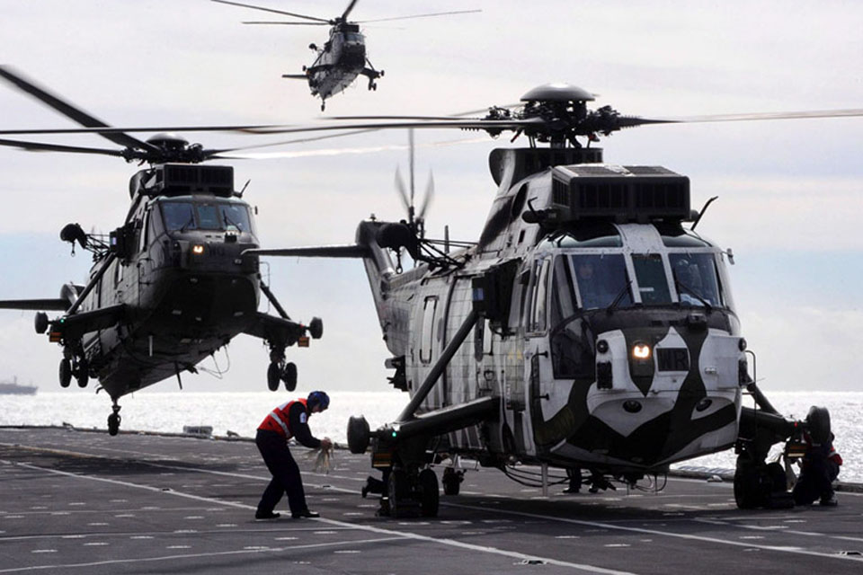 Three Sea Kings are recovered to the deck of HMS Illustrious 