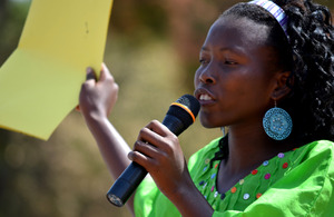 A woman speaks into a microphone at a public declaration for the abandonment of female genital cutting (FGC) in Ziguinchor, Senegal. Picture: Tostan International
