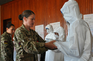 Medics from 5 Medical Regiment teaching the correct procedure for wearing personal protective equipment [Picture: Major Si Reeves RM, Crown copyright]