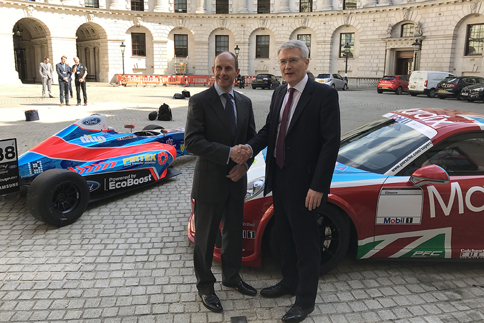 Roads Minister Andrew Jones and Ben Taylor, Managing Director, International Motor Sports, with a Porsche 911 GT3 Cup race car and a Mygale-Ford Formula 4 car.