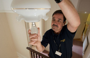 Handyperson fitting a lightbulb