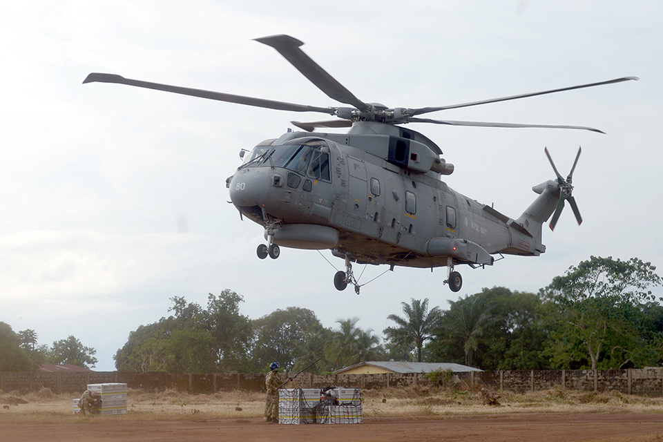 A Royal Navy Merlin helicopter delivers supplies 