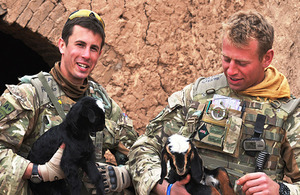 Soldiers from 5th Battalion The Royal Regiment of Scotland holding kids - baby goats - as part of the Veterinary Teaching Initiative near Lashkar Gah in Helmand province