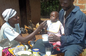 Metrine and her husband Matayo feed their 8-month-old son sweet potato. Picture: HarvestPlus