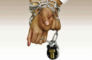 Male and female hands chained and padlocked together