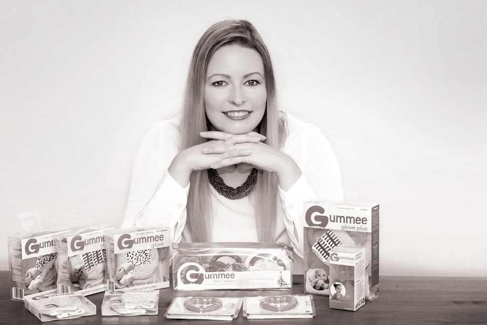 Picture of Jodine Boothby of Gummee in front of Gummee products.