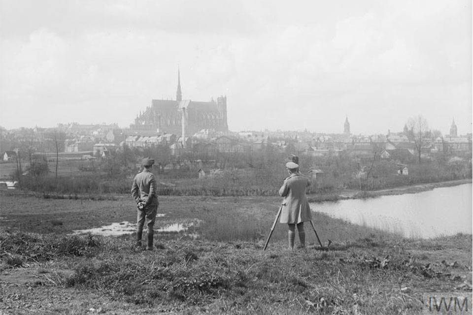 Lieutenant J. B. McDowell, British official cameraman, filming the town of Amiens, 7 April 1918. Note a clear view of the Cathedral