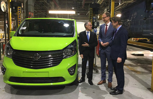 Greg Clark standing by a van in the Vauxhall plant.