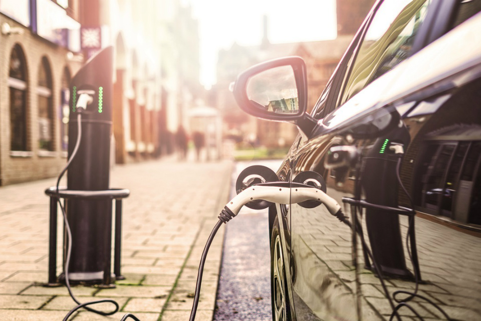 Electric car charging in street (credit: nrqemi/Shutterstock - ID609663695).