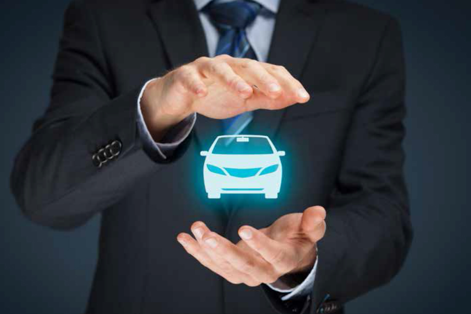 Hands holding a graphic of a car (credit: Jirsak/iStock - ID612225244).