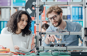 Engineering students use a 3D printer in a lab. Via Stokkete at Shutterstock