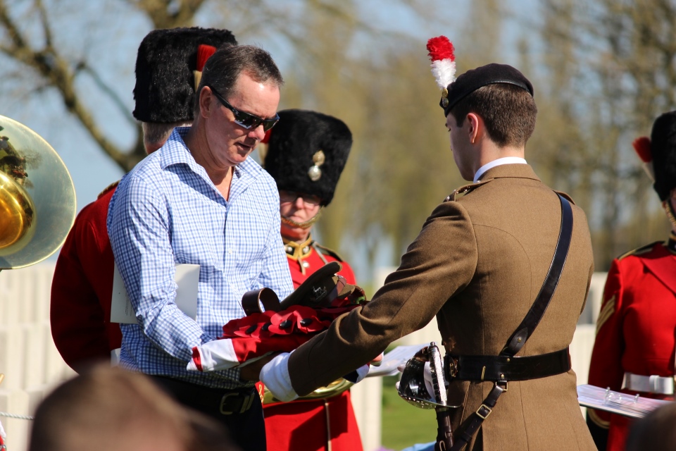 Great nephew Alistair Innes-Walker receives the Union Flag from Captain Alex Edmund, Crown Copyright, All rights reserved