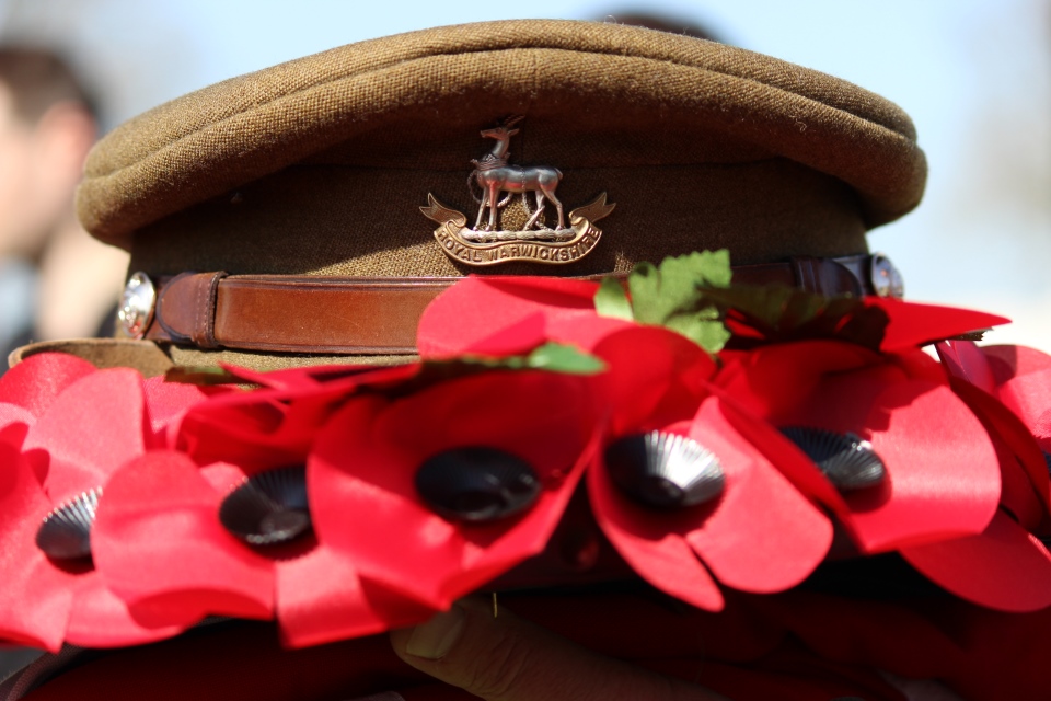 Royal Warwickshire cap amongst poppy wreath, Crown Copyright, All rights reserved