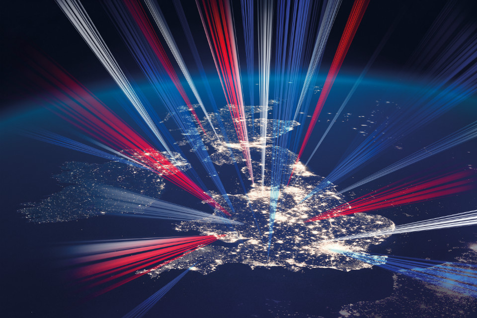 Illustration of the UK at night with red, white and blue lasers (detail of the Industrial Strategy front cover).