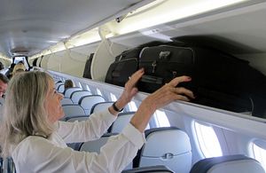 Passenger on plane with luggage